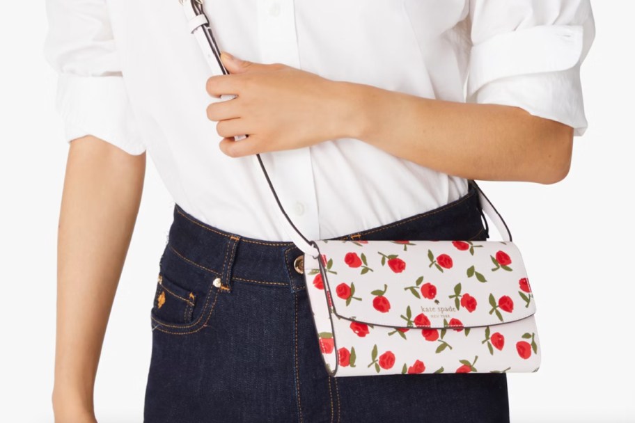 woman holding cherry crossbody bag