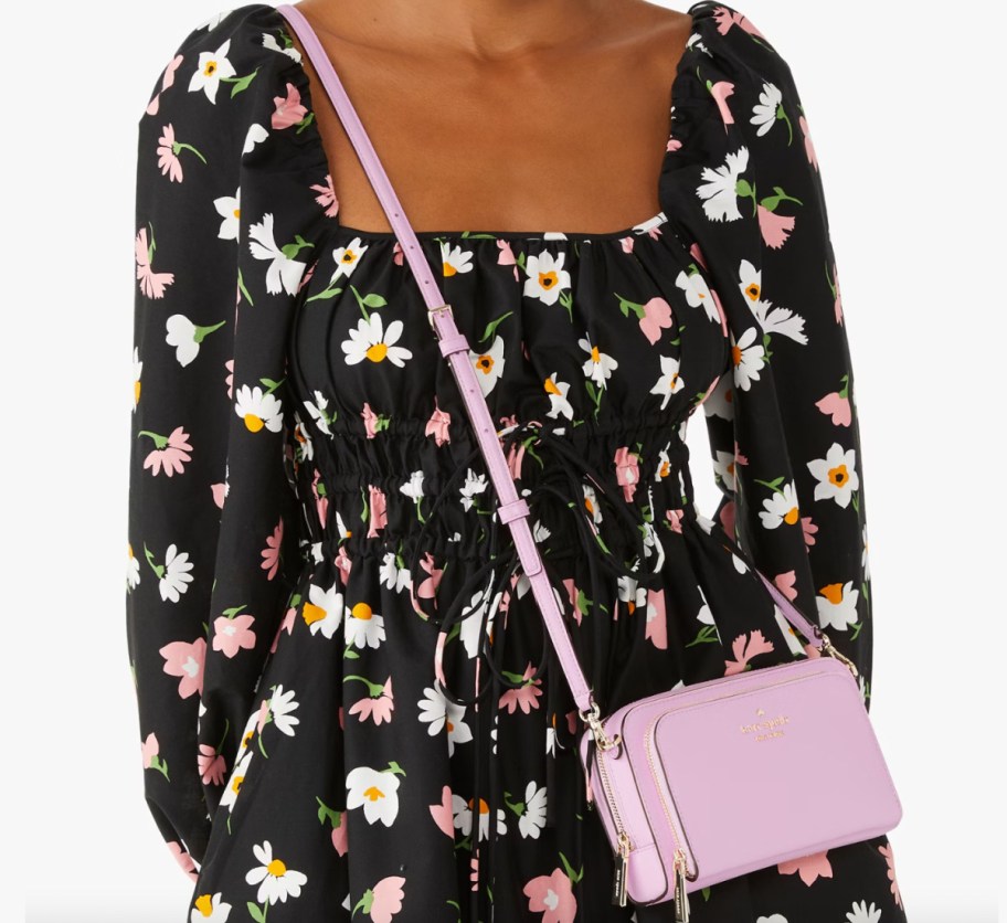 woman in black floral dress with pink purse