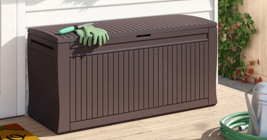 brown keter storage box with green gloves 