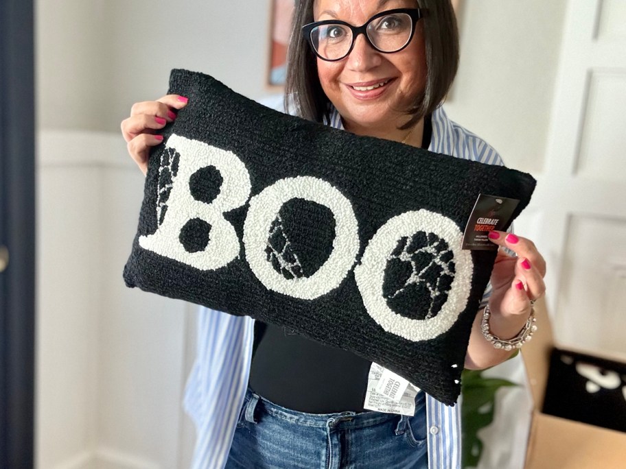 woman holding boo pillow