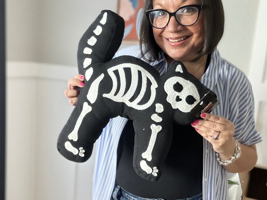 woman holding cat skeleton pillow