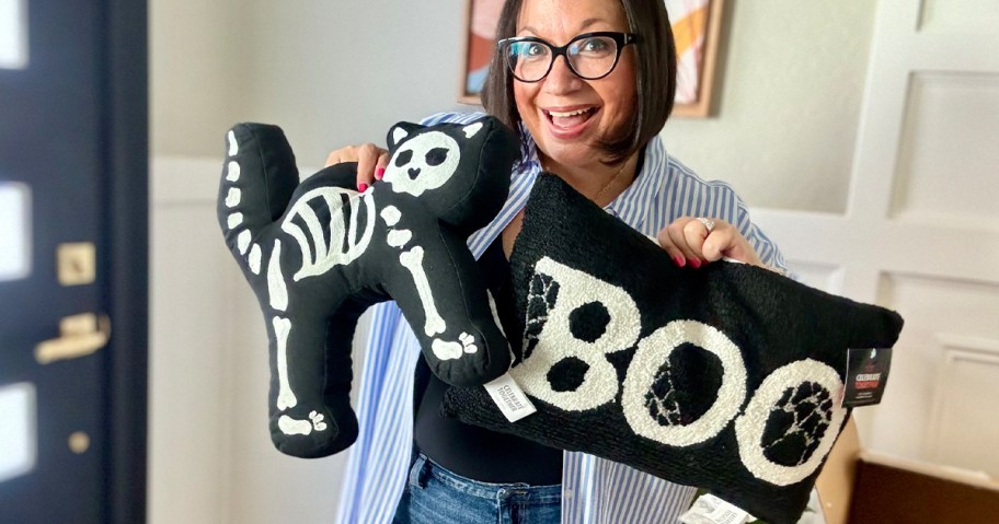 lina holding skeleton cat and boo pillows