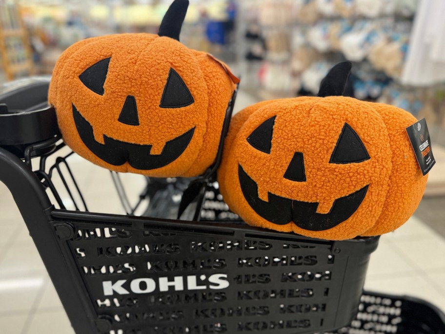 two pumpkin throw pillows in shopping cart 