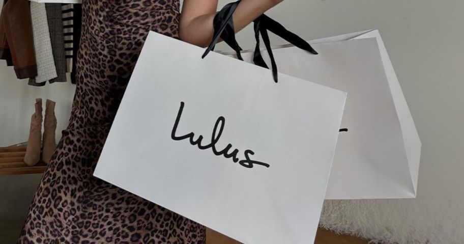 woman holding two lulus bags