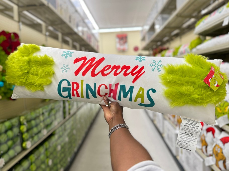 hand holding merry grinchmas pillow