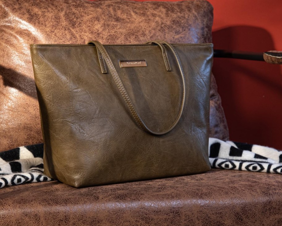 dark olive green tote bag on leather chair