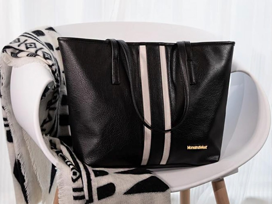 black and white striped montana west leather tote on white chair