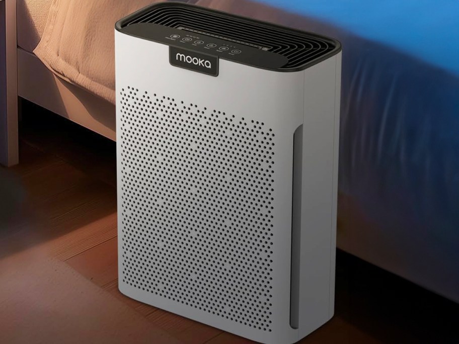 white mooka air purifier next to bed