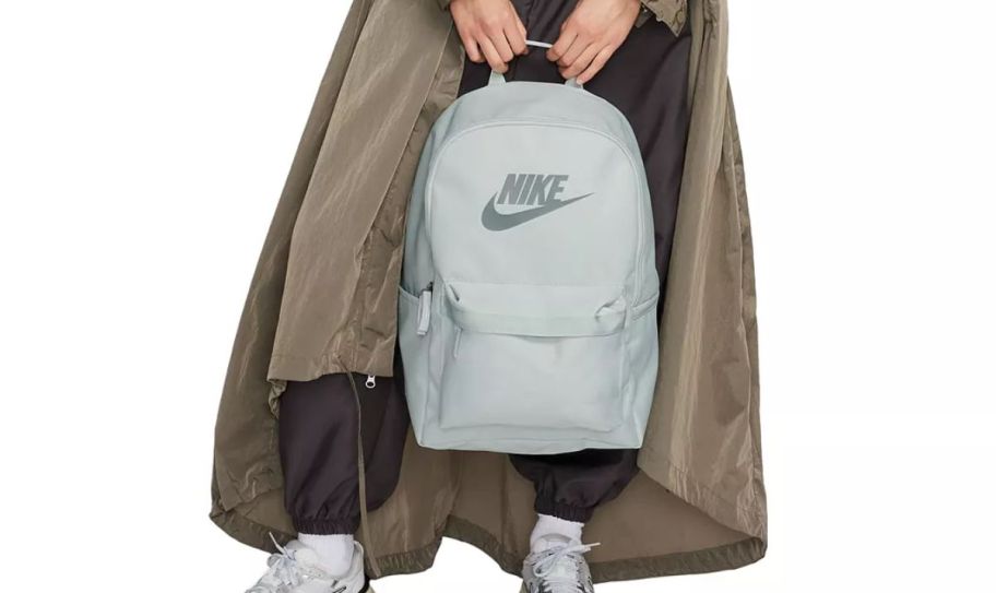 a girl carrying a nike backpack 