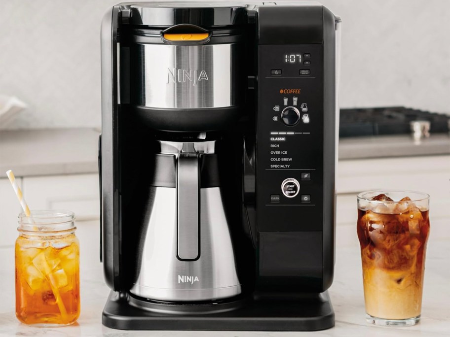 black and stainless ninja coffee maker next to drinks on table