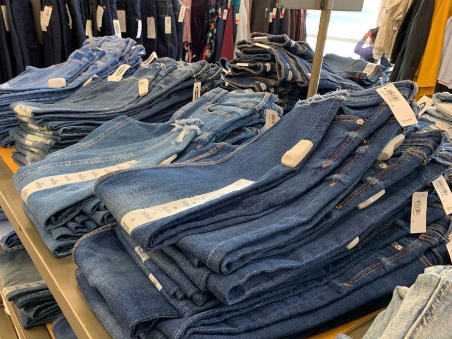 old navy jeans on table in store