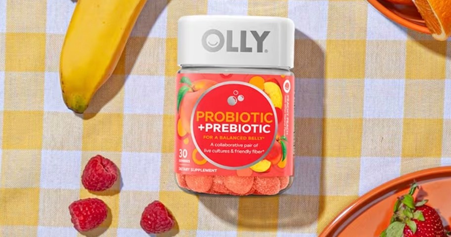olly probiotic bottle on table with fruit