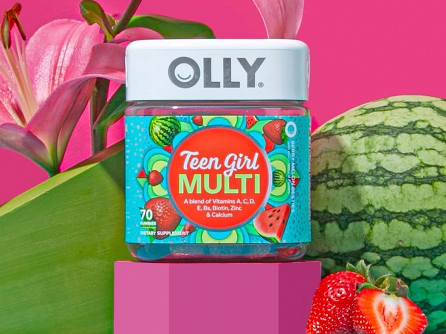 olly teen girl vitamin bottle next to strawberries and watermelon