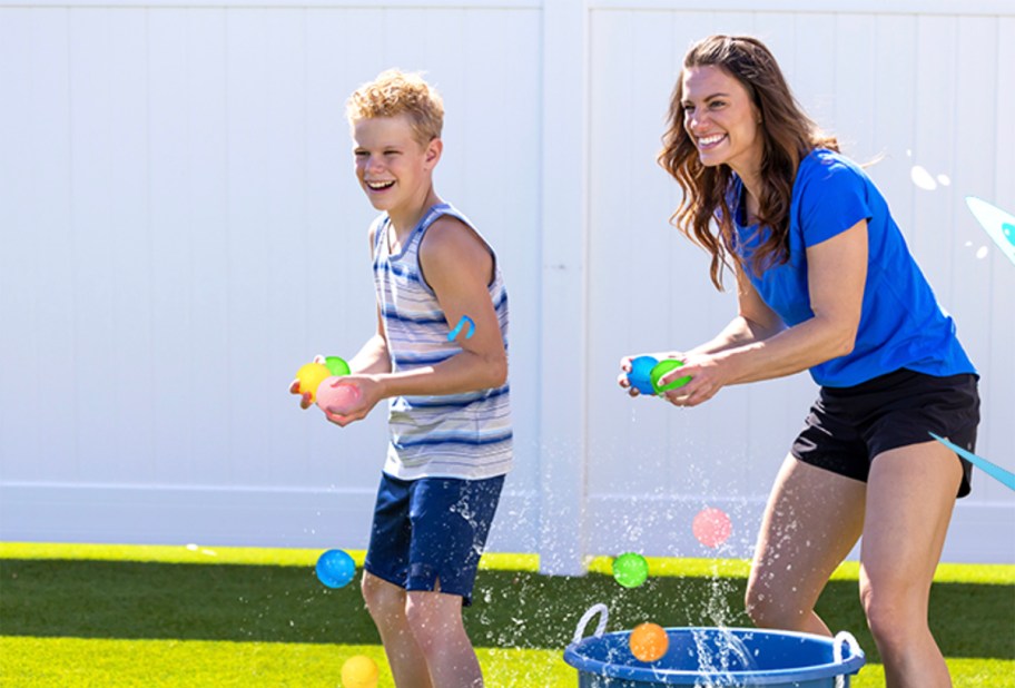 two people holding water balloons