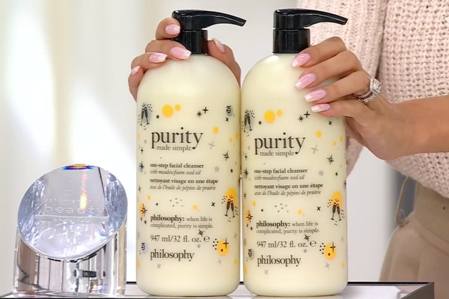 hands grabbing purity cleanser bottles