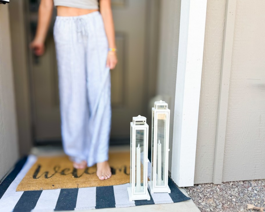 two tall white lanterns near front door