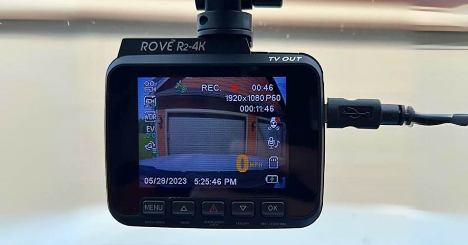 Rove dash cam on a car inside windshield showing the garage door behind the vehicle