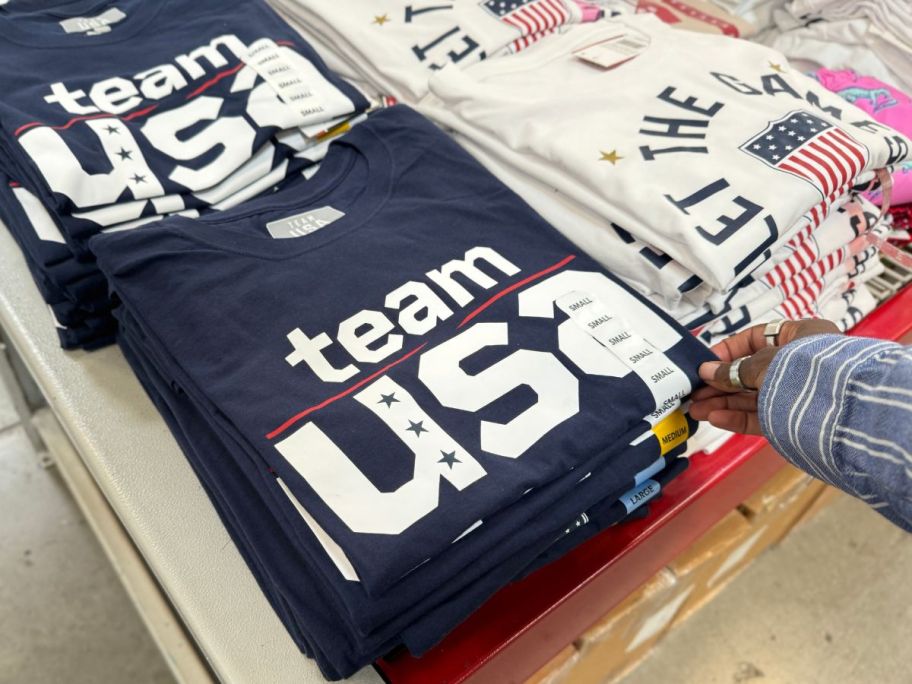 Team USA Men's Short Sleeve Tees stacked on table in store