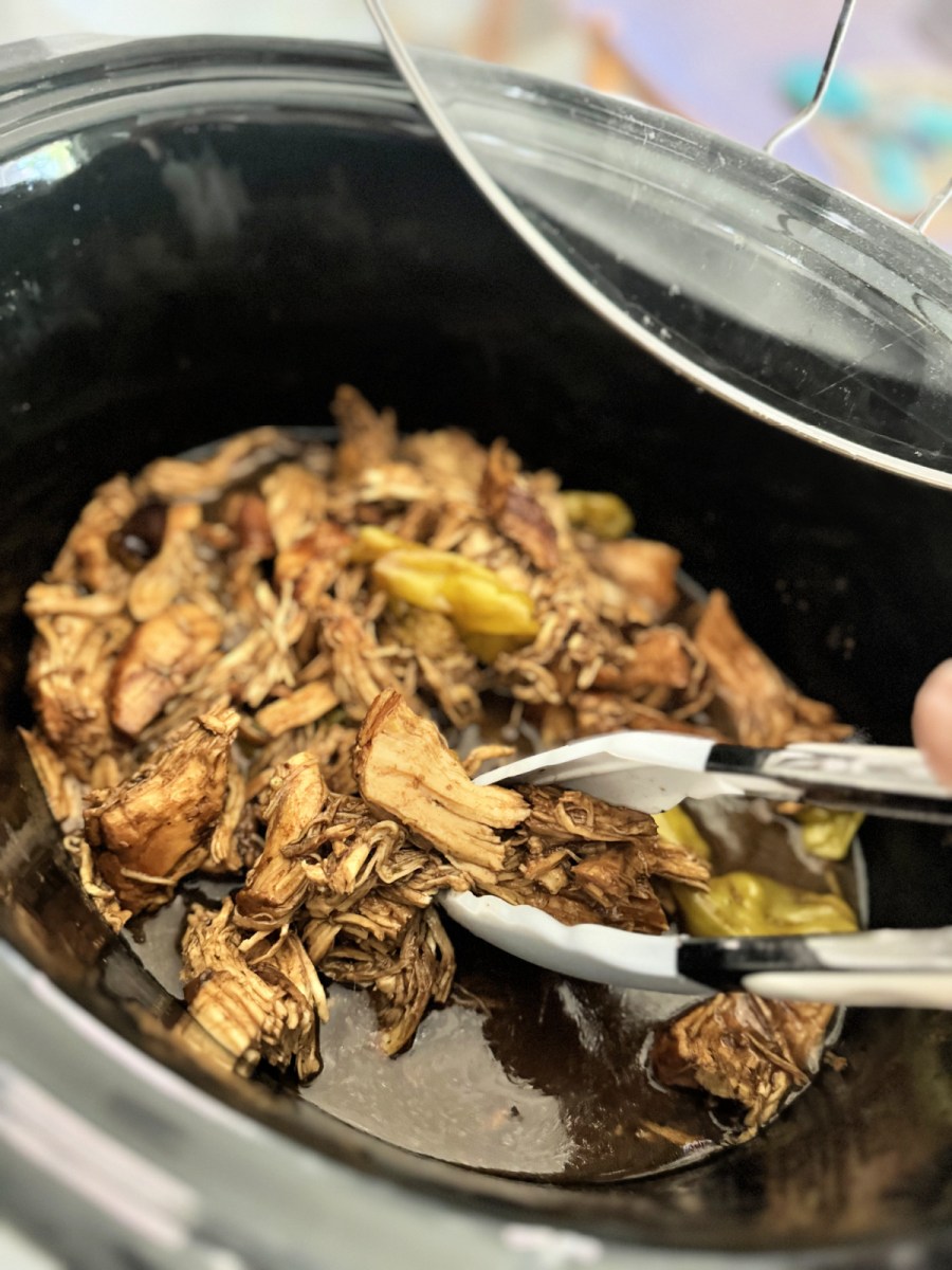 slow cooker with mississippi chicken inside after cooking 