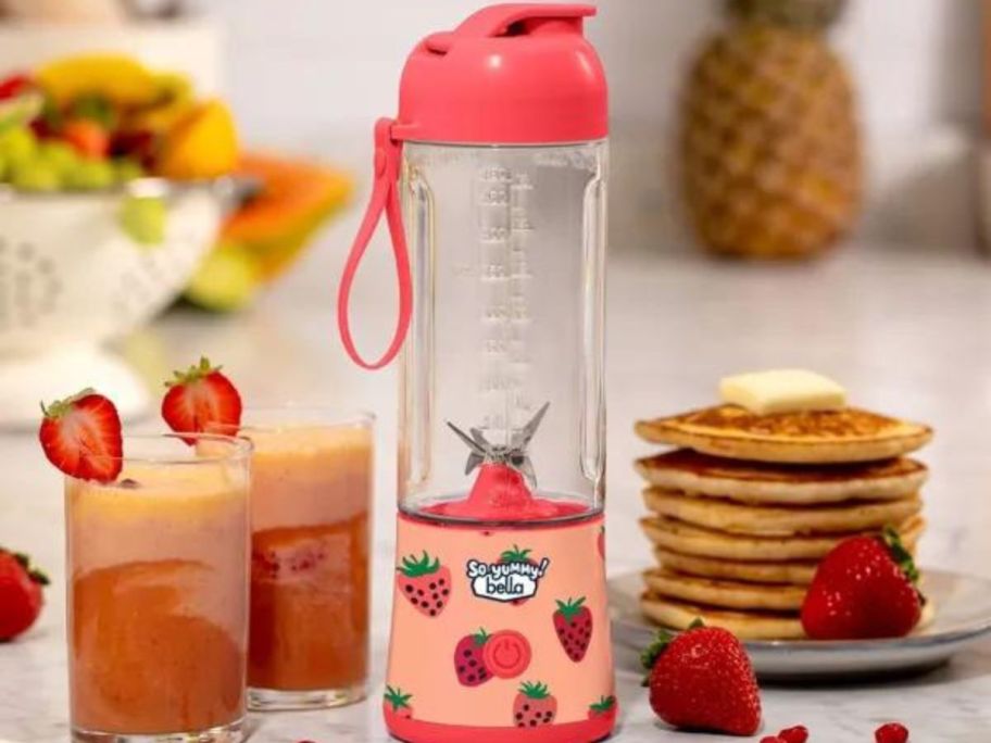 So Yummy by bella Portable To-Go Blender sitting next to pancakes and glasses