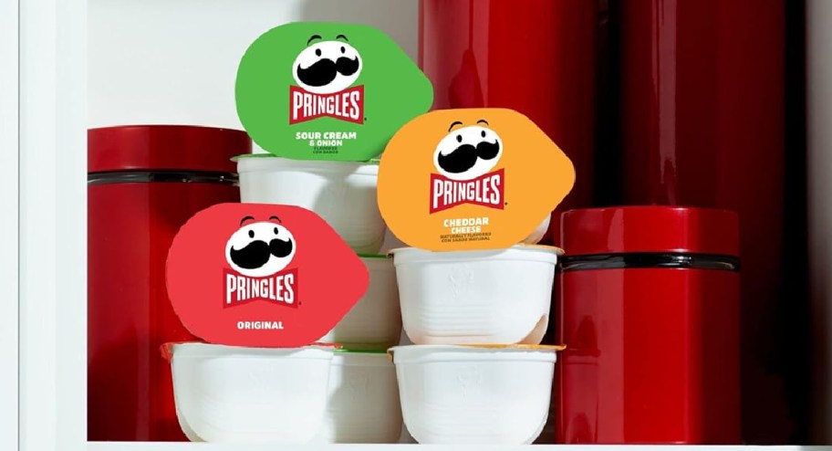 stack of pringles displayed insdie of a cabinet