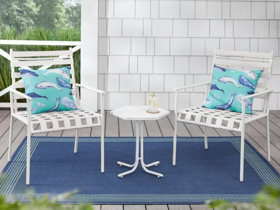 two white dining chairs on patio 