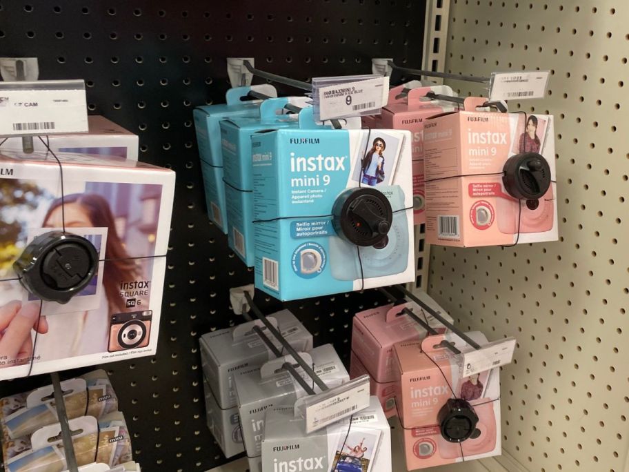 camera boxes hanging on racks in store