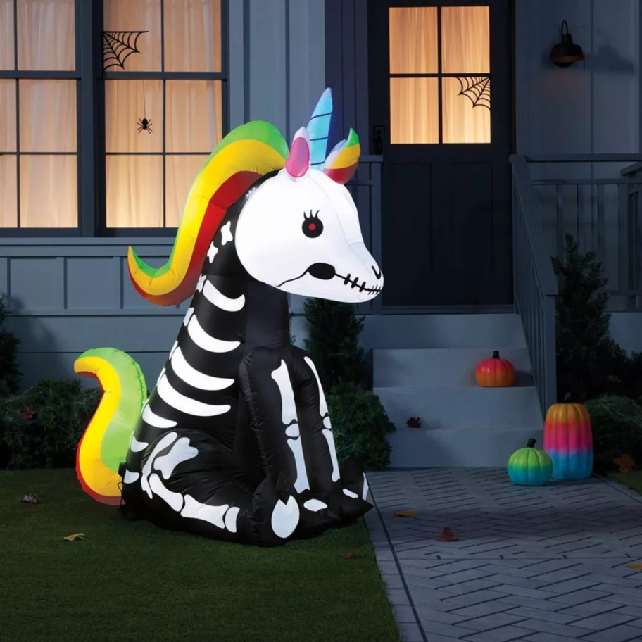 large Inflatable Skeleton Unicorn Halloween decor outside a house 
