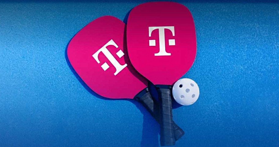 two pink pickleball paddles and ball 