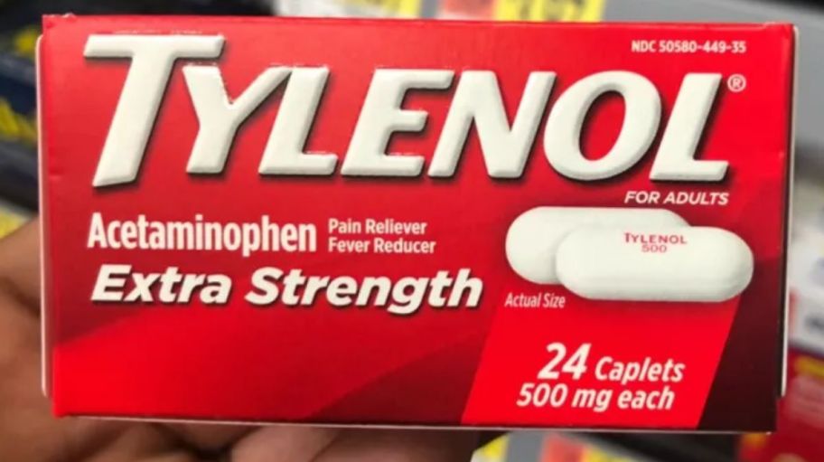 a hand holding a box of extra strength Tylenol