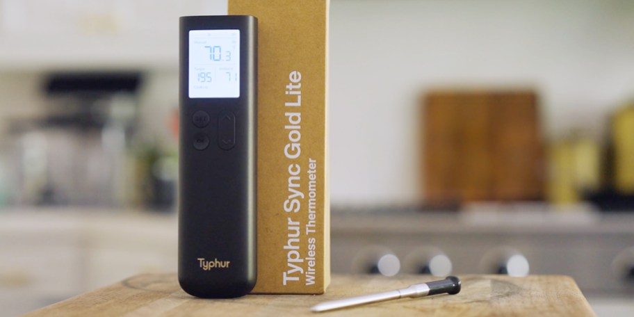 themometer on cutting board with base next to it