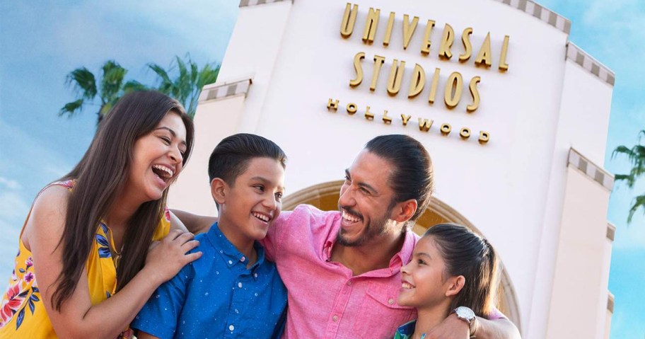 family standing in front of universal studios hollywood sign