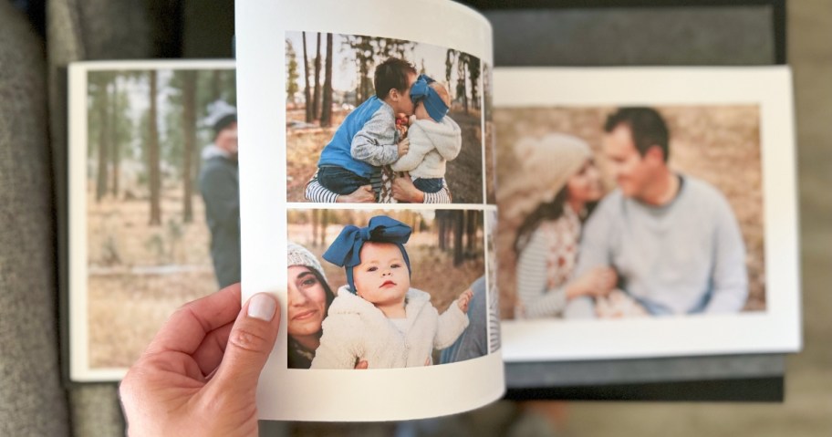hand flipping through a custom photo book with pictures of a family