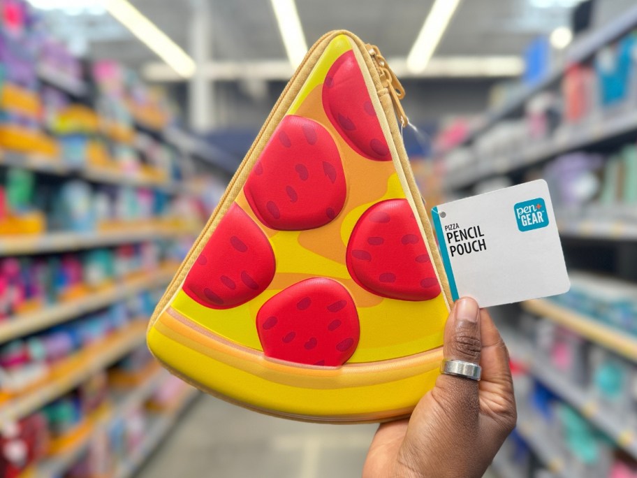 hand holding a pizza shaped pencil case in a store aisle