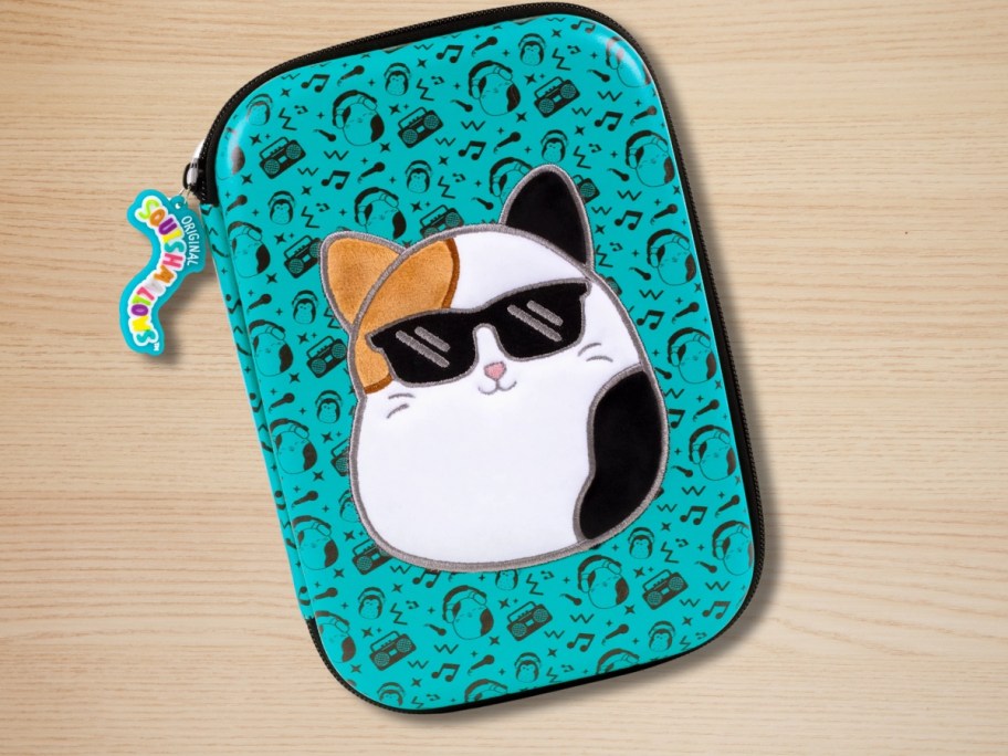 teal green Squishmallows pencil case with Cam the Cat on a desk