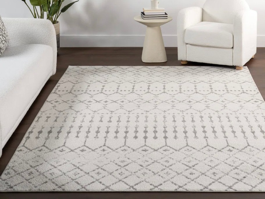 black and white area rug with design next to white couch