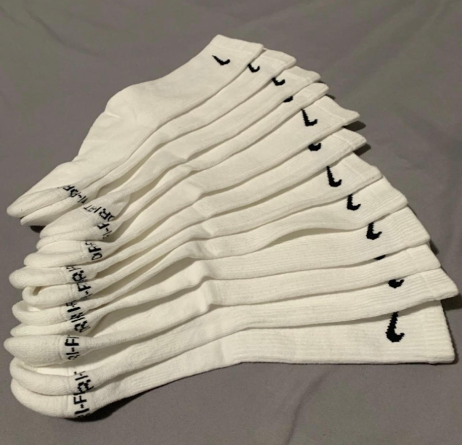 pile of new white nike high socks on sheet