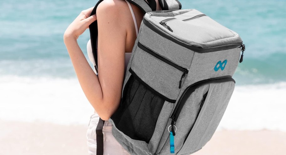 woman wearing large cooler backpack in grey with blue accents