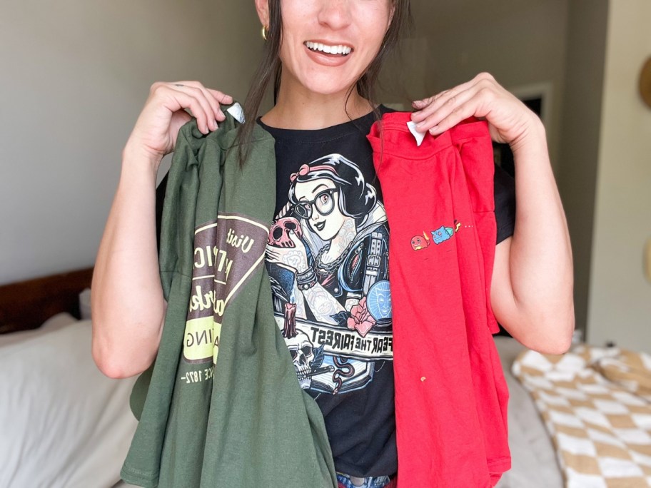 woman holding up 3 graphic tshirts in different colors and prints