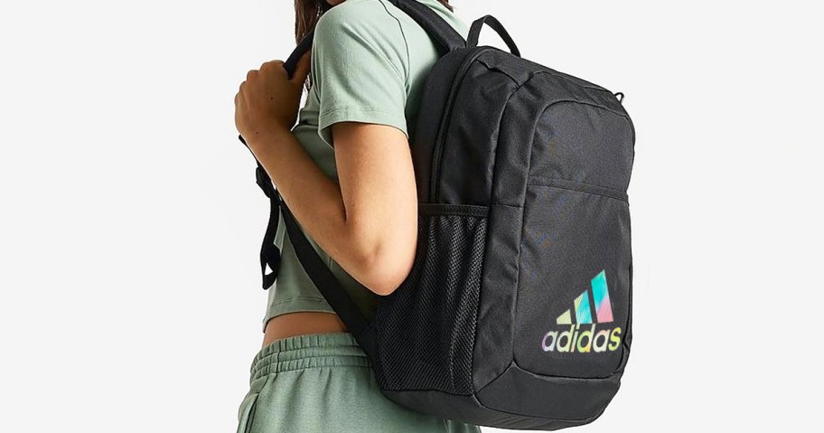 girl wearing a black adidas backpack