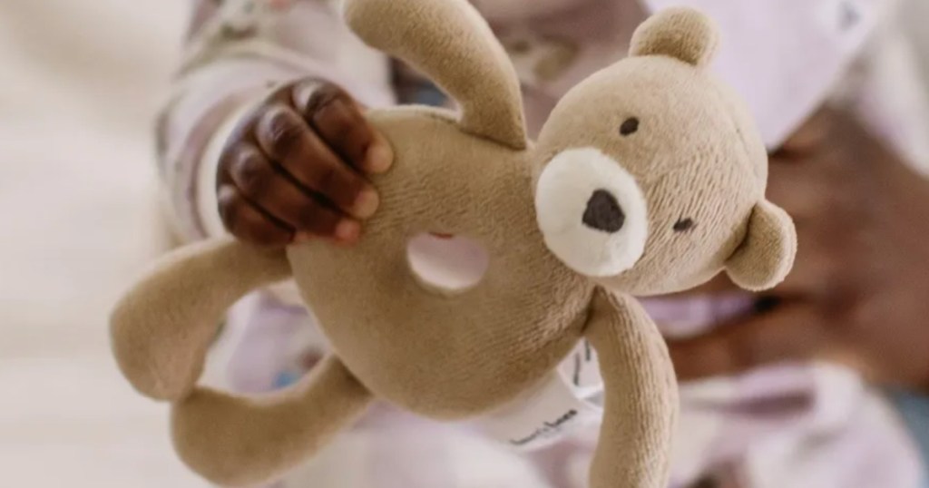 baby holding bear Burts Bees Rattle