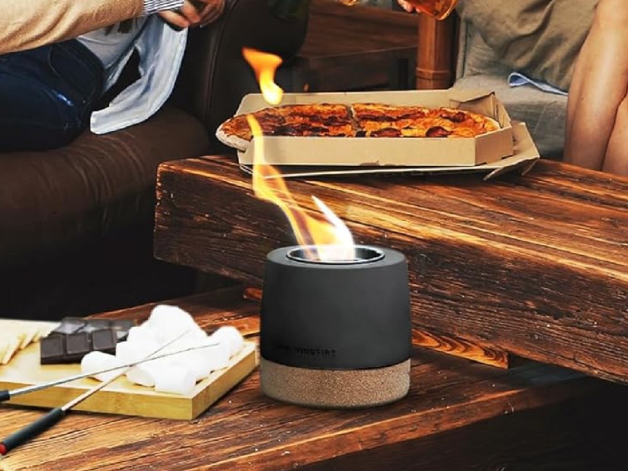 Concrete Small Table Top Firepit on a table displayed with people behind it-2