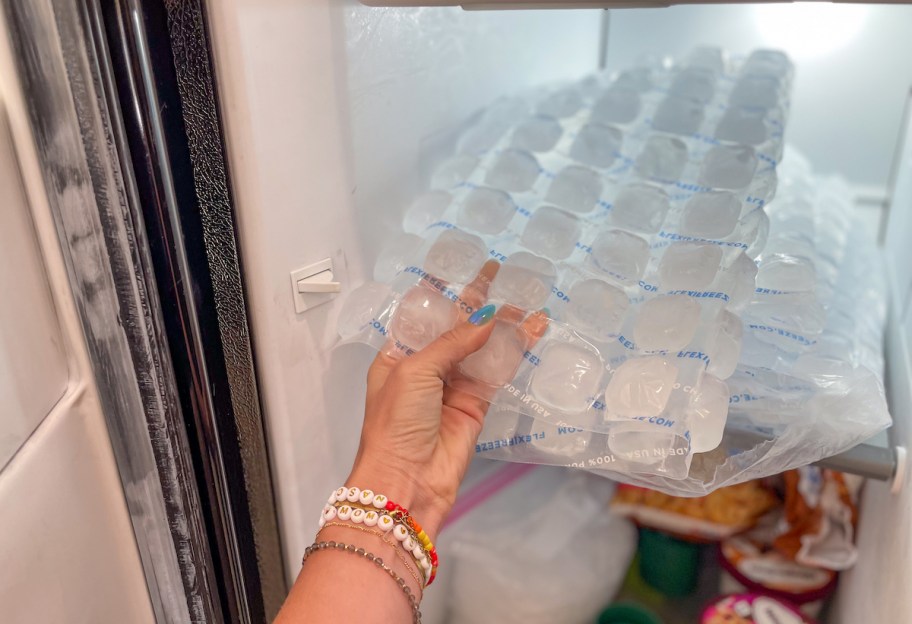 hand taking FlexiFreeze Ice Sheets out of freezer