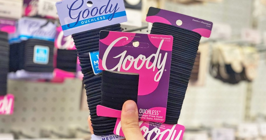 hand holding three packs of goody hair ties in store