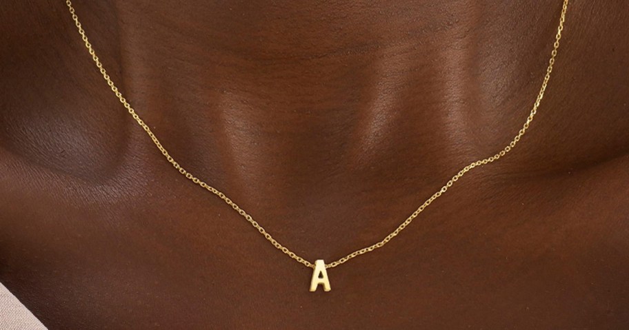 woman wearing a gold letter A initial necklace