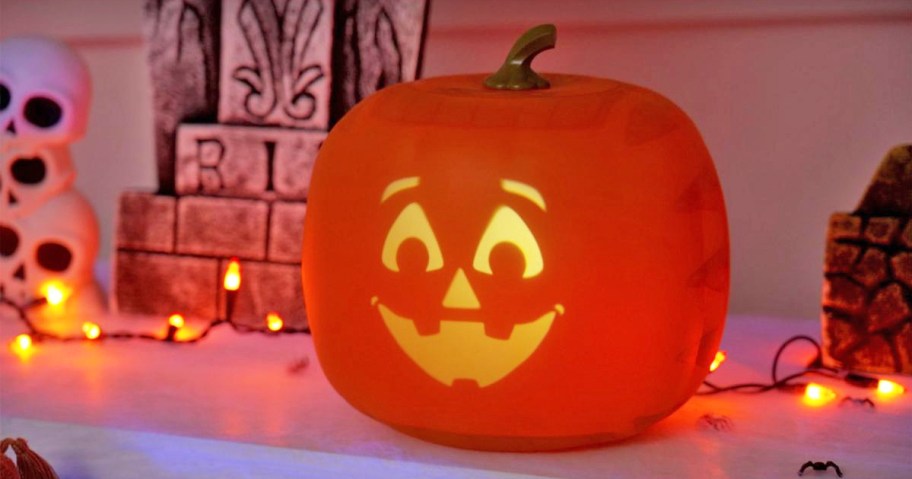 animated pumpkin on table with orange lights