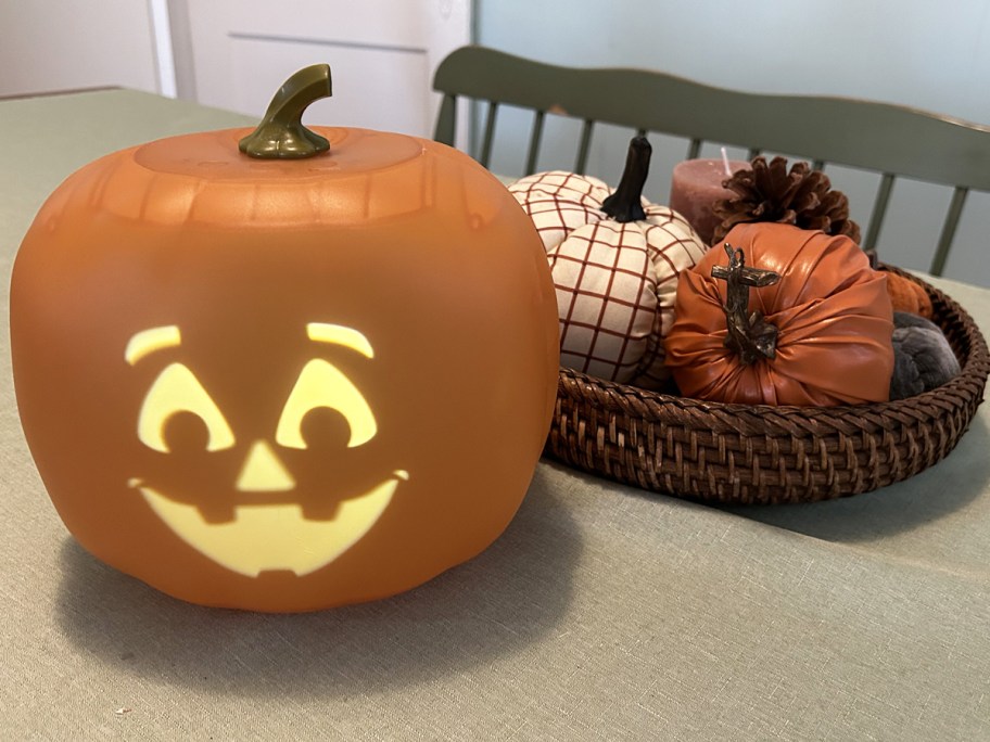 animated pumpkin on table next to decorative pumpkins