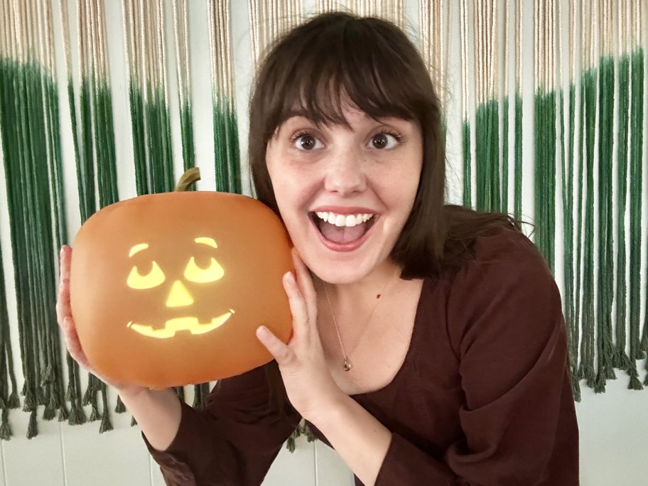 woman holding up an animated pumpkin