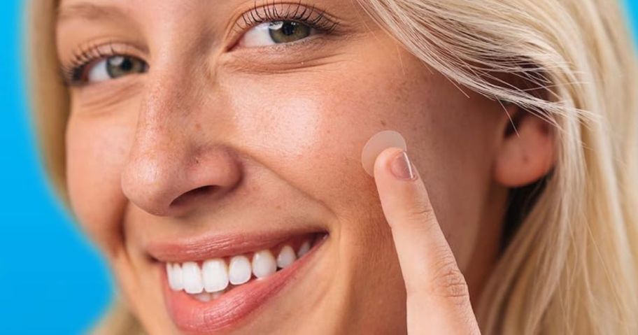 Woman putting a KeyConcepts Pimple Patch on her cheek