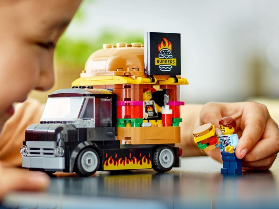 child playing with LEGO City Burger Truck set